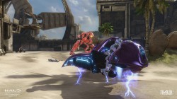 In-game screenshot from the multiplayer for Halo 2. A player from the Red Team is about to hijack a Ghost from another player from the Blue Team.