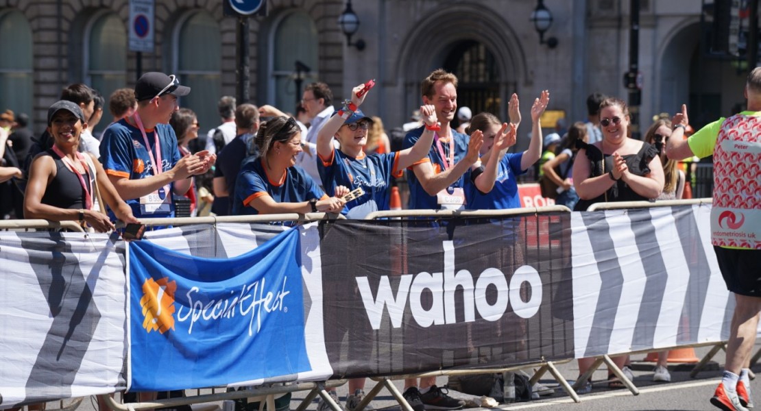 Special Effect team cheering the runners on from behind the barriers near the finishing line.