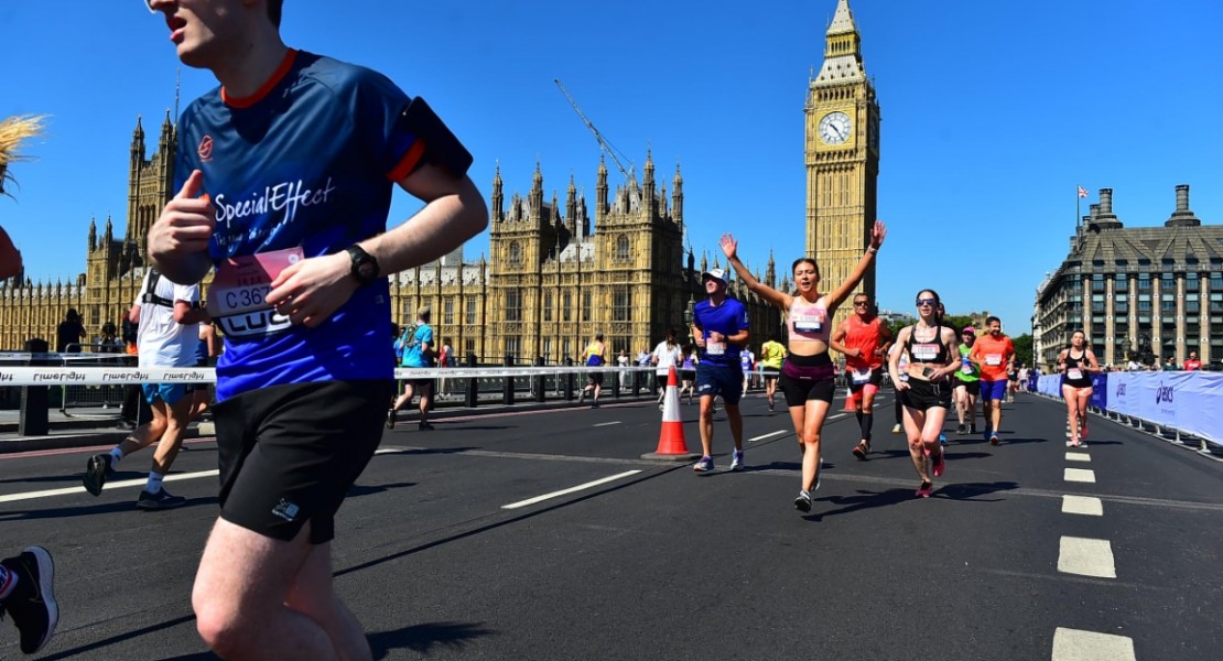 A picture of myself (Luc Shelton) in a SpecialEffect athletic jersey, running across the London Bridge. Behind me in the distance is the Palace of Westminster and Big Ben.