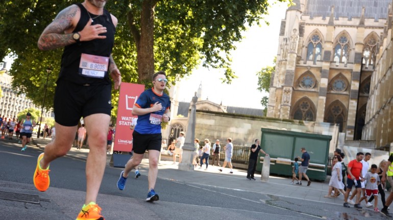 Another picture of myself (Luc Shelton) running past the Palace of Westminster. There is someone to my left. I am wearing a SpecialEffect athletic jersey.